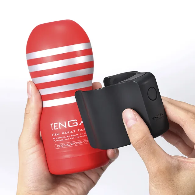 Black Tenga Cup Vibrator held beside red striped cup