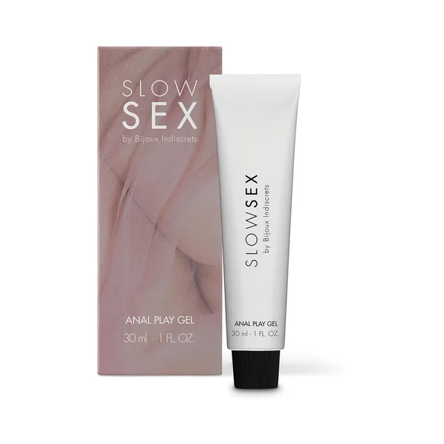 white Slow Sex Anal Play Gel tube with black cap beside blush-colored carton