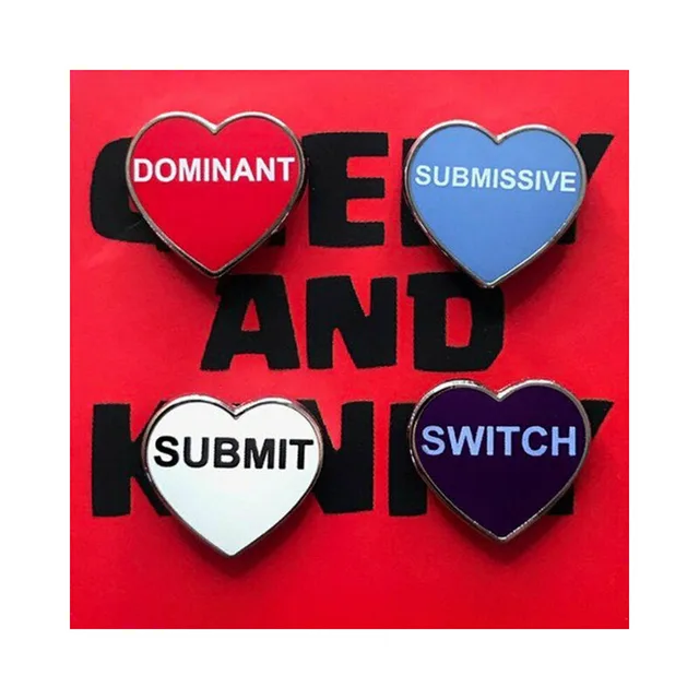four heart pins reading Dominant, Submissive, Submit and Switch on red card