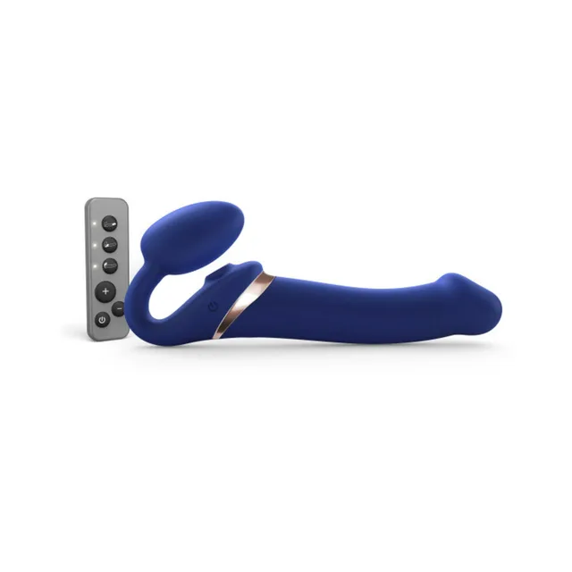 Large night-blue bendable strapless strap-on beside remote