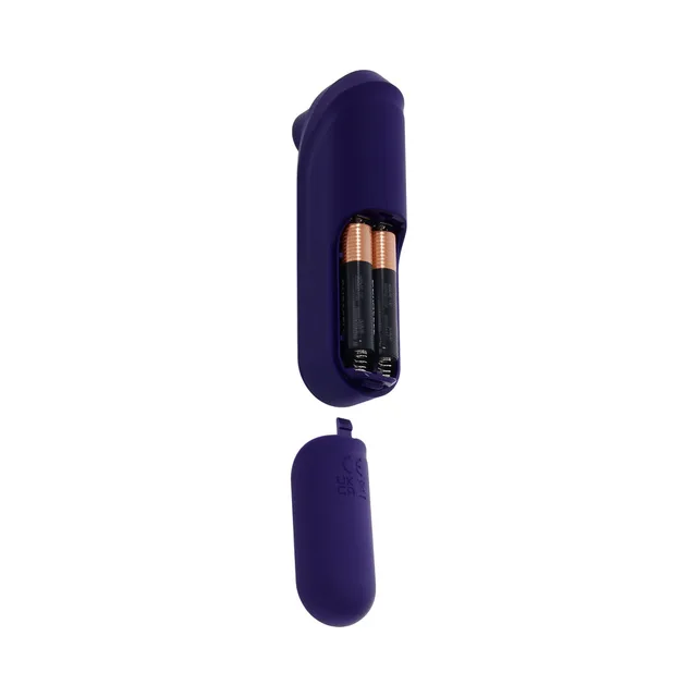 Open battery compartment on purple Sure Thing holding three AAA batteries