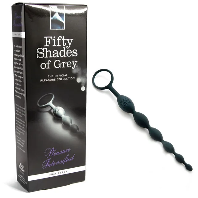 Fifty Shades Pleasure Intensified black graduated bead strand beside tall black box