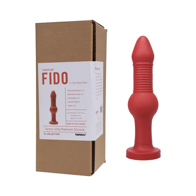 Red Tantus Fido dildo beside labeled brown retail box