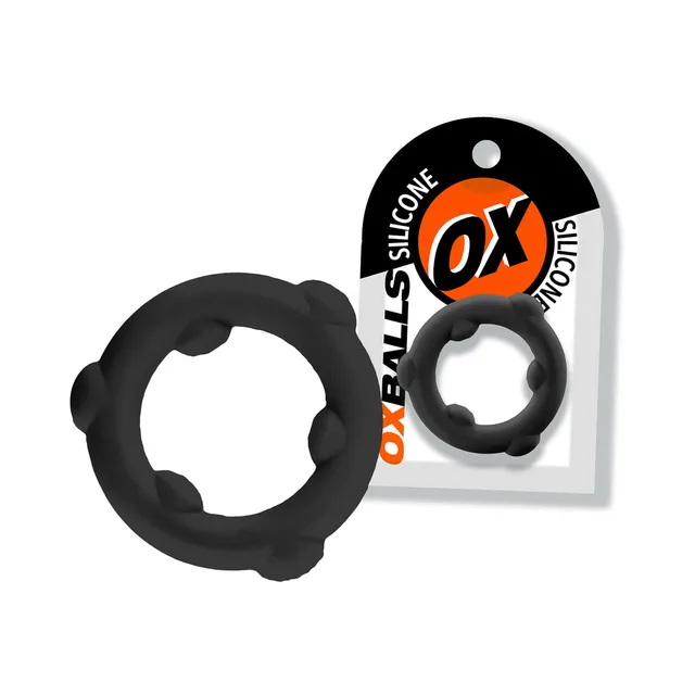 Black Oxballs Spinner ring with six raised nodes beside card
