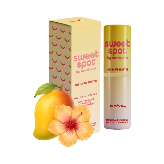 Sweetums Sweet Spot hibiscus hottie flavored fragrance tube and box arranged with mango and hibiscus flowers