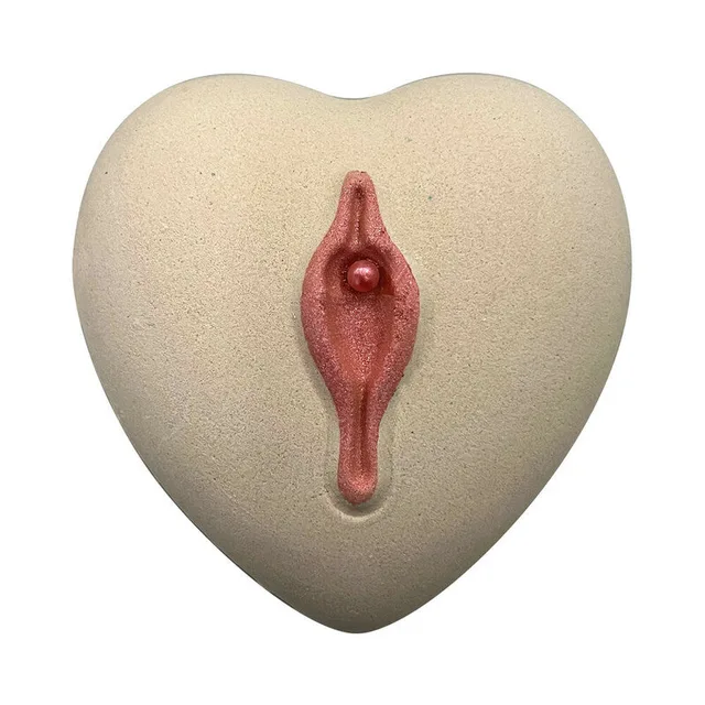 ivory heart-shaped Love Your Pussy bath bomb with raised pink anatomical center