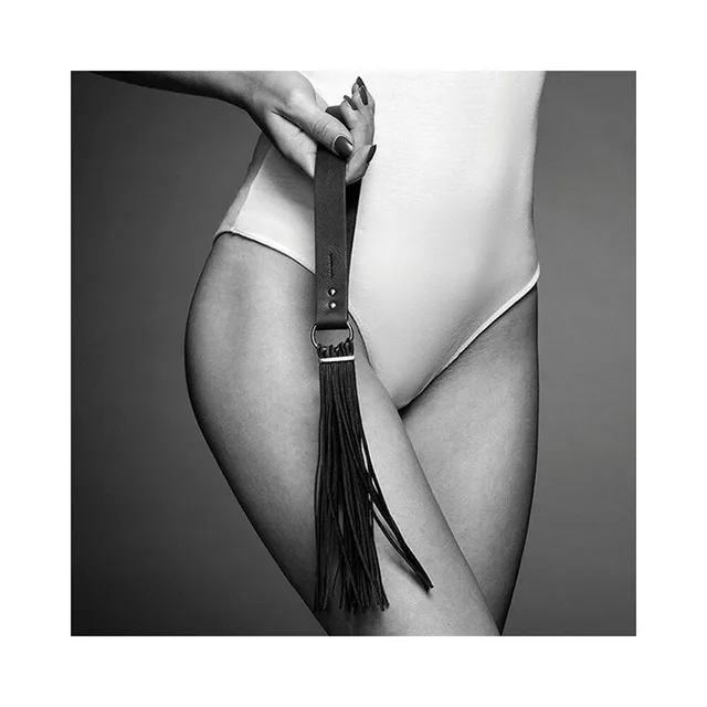black Maze tassel flogger with flat buckled handle and long narrow tails held by model