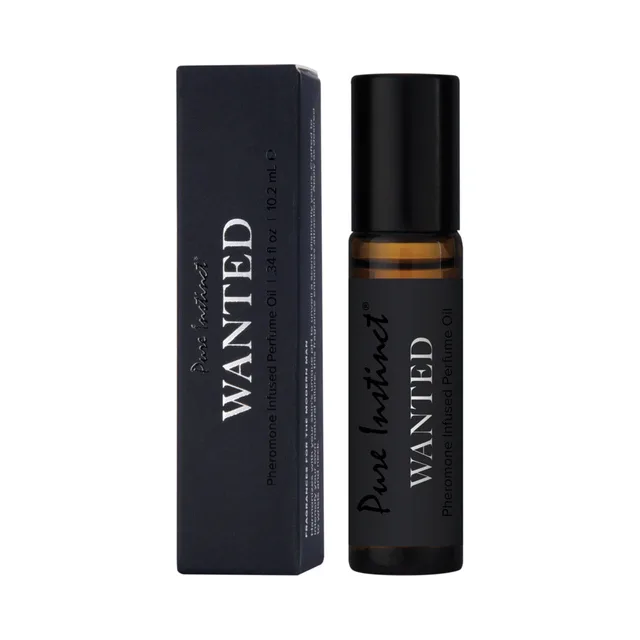 Pure Instinct Wanted amber roll-on perfume oil beside black box