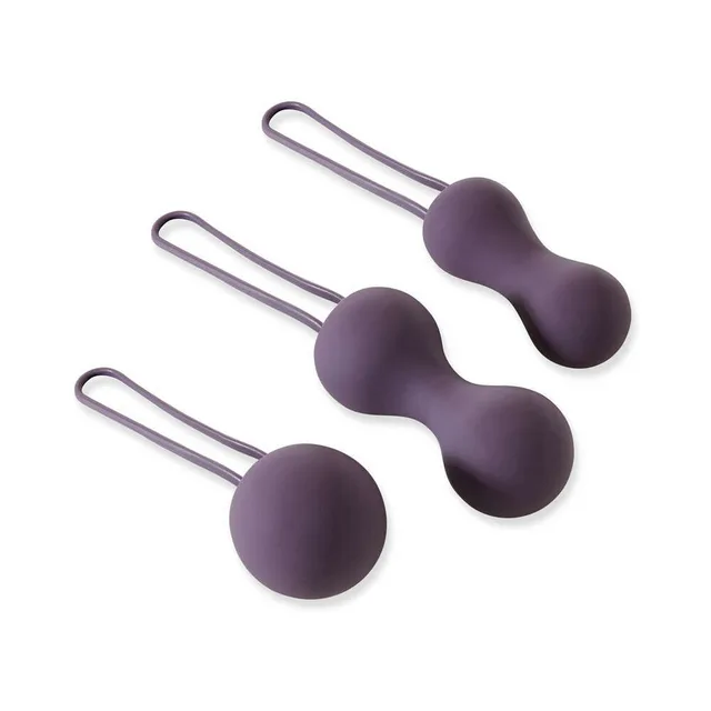 Three purple Ami Kegel weights arranged with retrieval loops