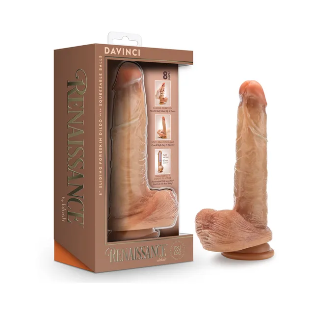 tan Renaissance DaVinci dildo with sliding foreskin and textured balls beside box