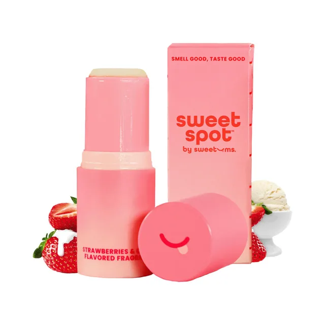 Open pink Sweet Spot fragrance stick with strawberries and cream props
