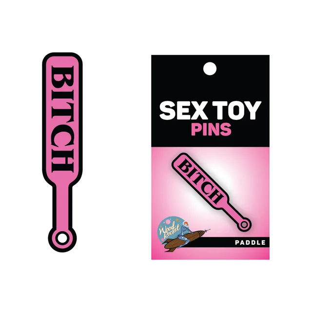 hot pink Bitch paddle enamel pin beside black and pink Sex Toy Pins card