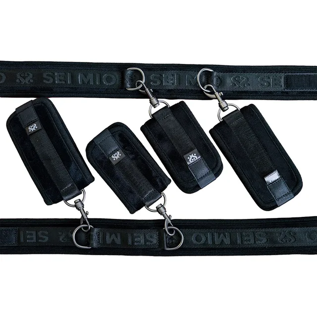 Black thigh bands and four padded cuffs with clips and short chains