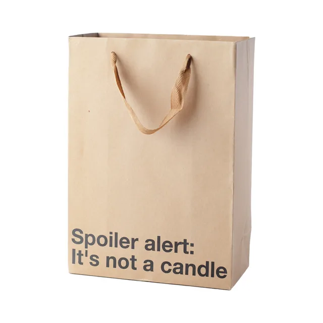 tan gift bag reading Spoiler alert It's not a candle
