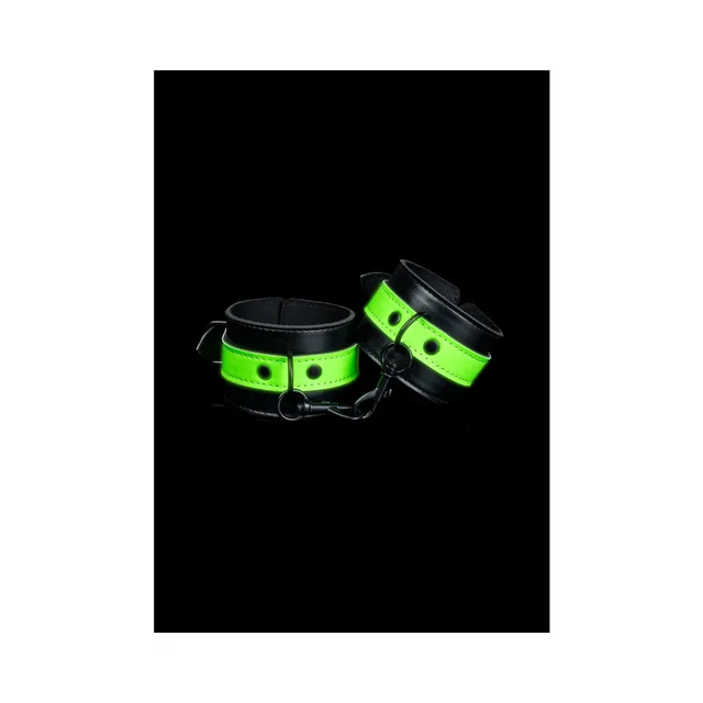 Pair of black cuffs with neon-green panels and chain
