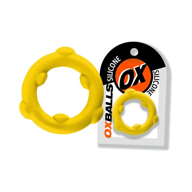 Yellow Oxballs Spinner ring with six raised nodes beside card
