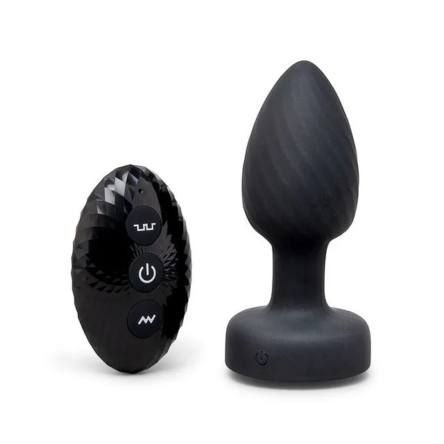 b-Vibe 3.5-inch black light-up plug standing beside faceted button controller