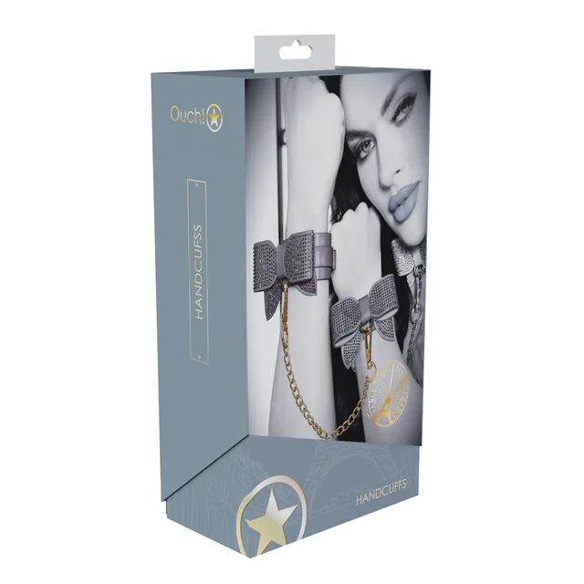 iridescent Paris handcuffs with rhinestone bows and gold chain on box