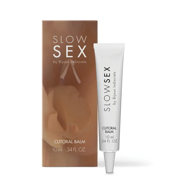 slim white Slow Sex Clitoral Balm tube beside a brown-toned retail carton