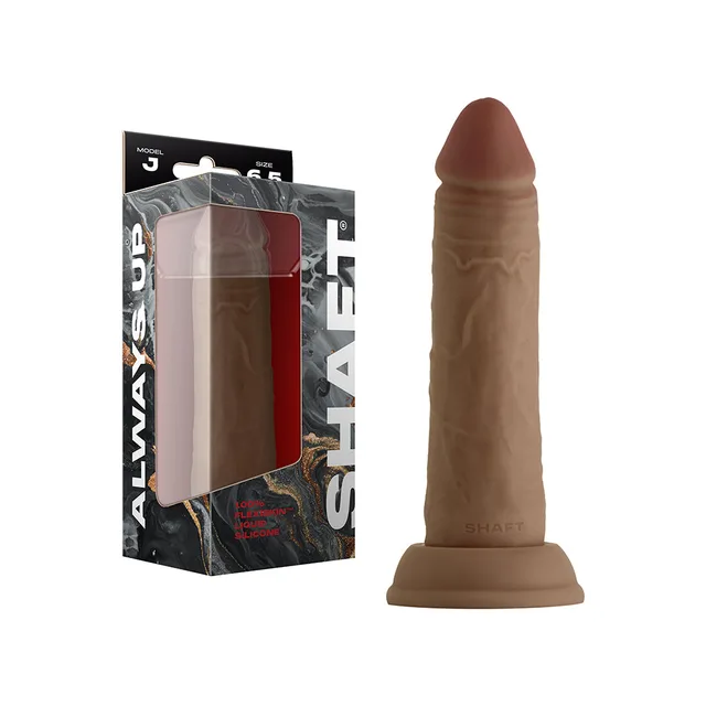 Shaft Model J 6.5-inch oak dildo beside windowed retail box