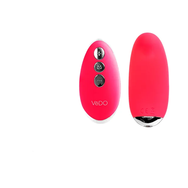 Foxy pink Niki curved vibrator beside oval three-button remote
