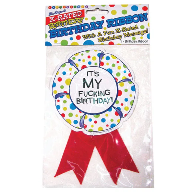 White explicit birthday badge with red ribbon tails in package