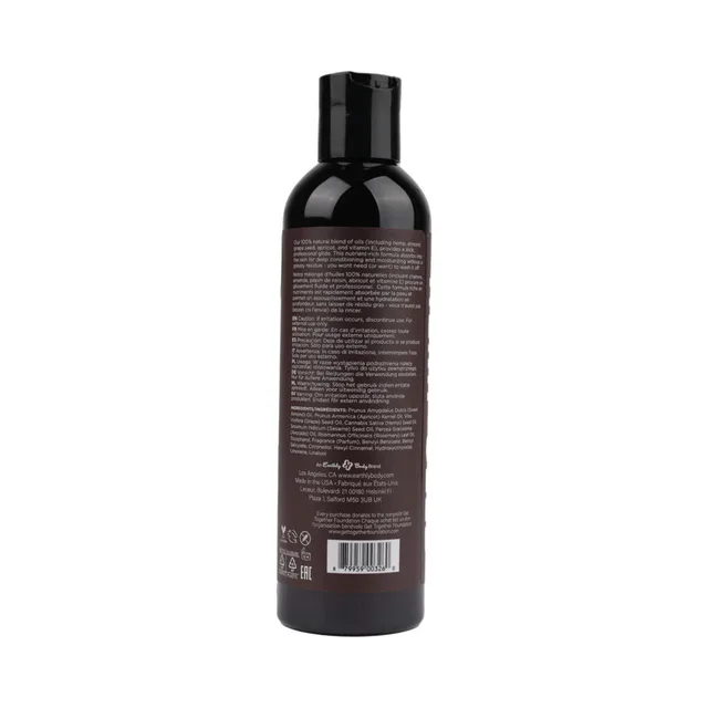 Earthly Body Guavalava Massage Oil dark bottle rear with dense text and barcode