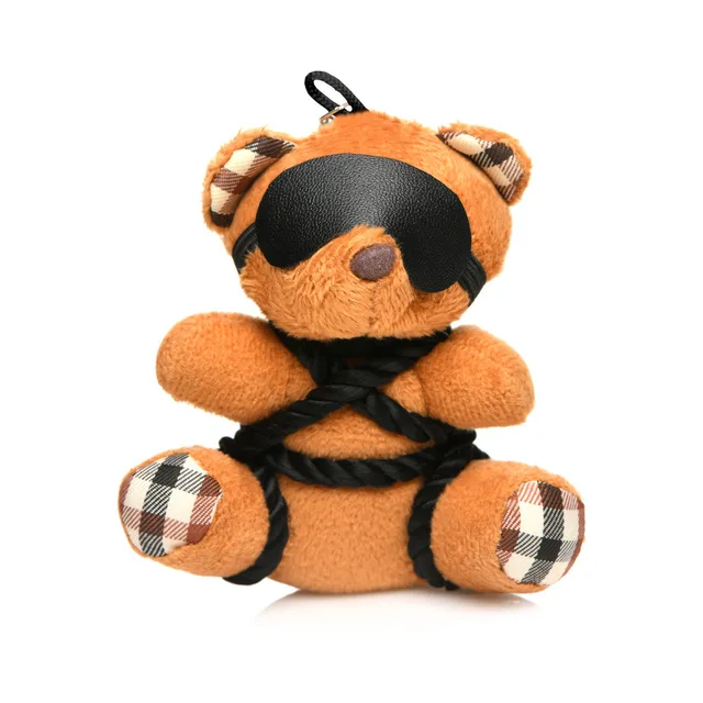 orange teddy bear keychain with black eye mask and crisscross rope wrapping