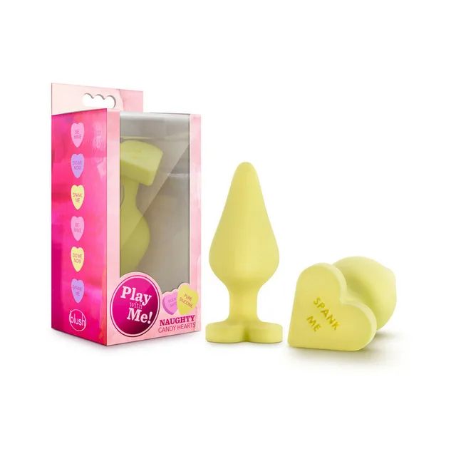 Naughty Candy Hearts Spank Me yellow plug and heart base beside package