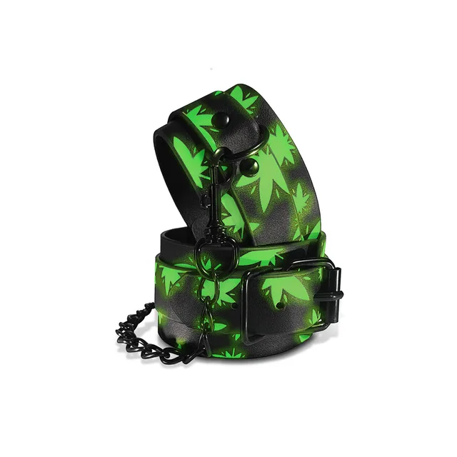 folded green leaf print ankle cuffs with black buckles and chain