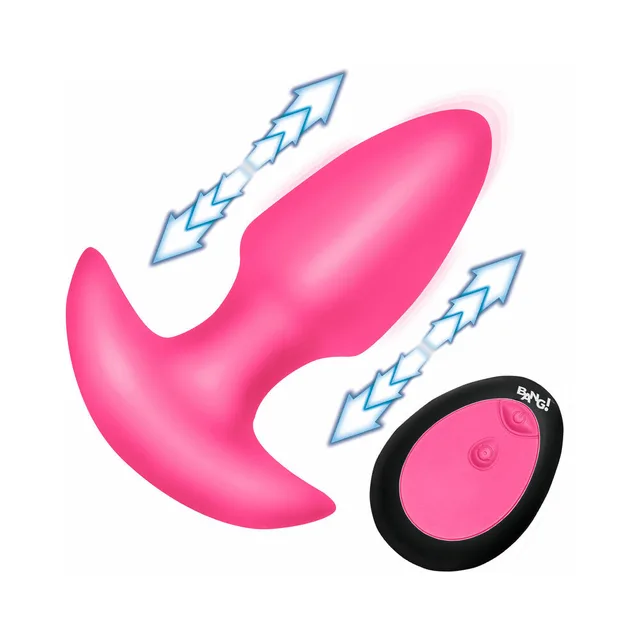 BANG pink silicone thrusting butt plug beside the black oval remote with motion arrows