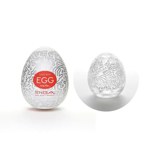 Tenga Keith Haring Party Egg case beside clear embossed sleeve