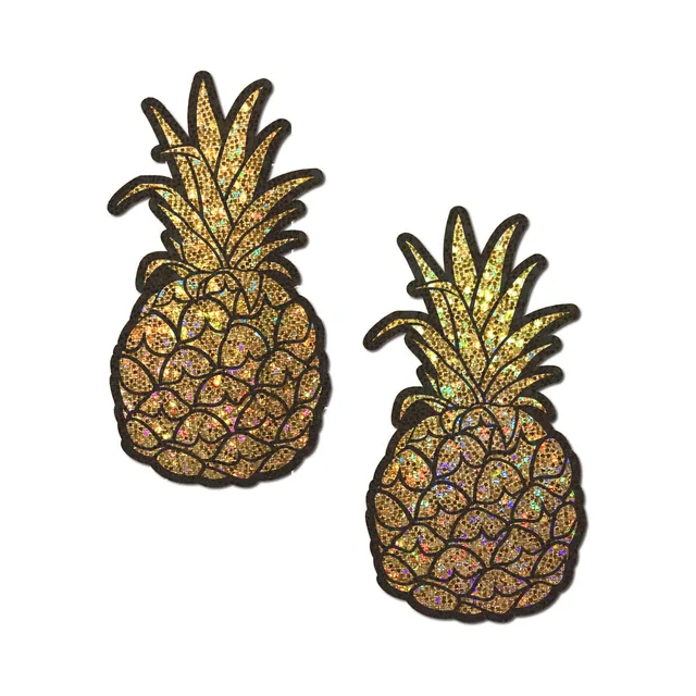 pair of gold holographic glitter pineapple nipple covers with black etched details