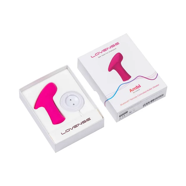 Pink Lovense Ambi bullet vibrator in open box beside charging disc