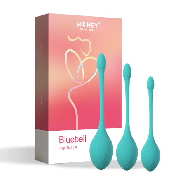 three teal Bluebell weighted Kegel balls in graduated sizes beside coral box