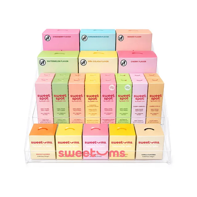 Sweetums pastel intimate-care countertop display assortment with rows of pastel boxes and packets arranged in a white tray
