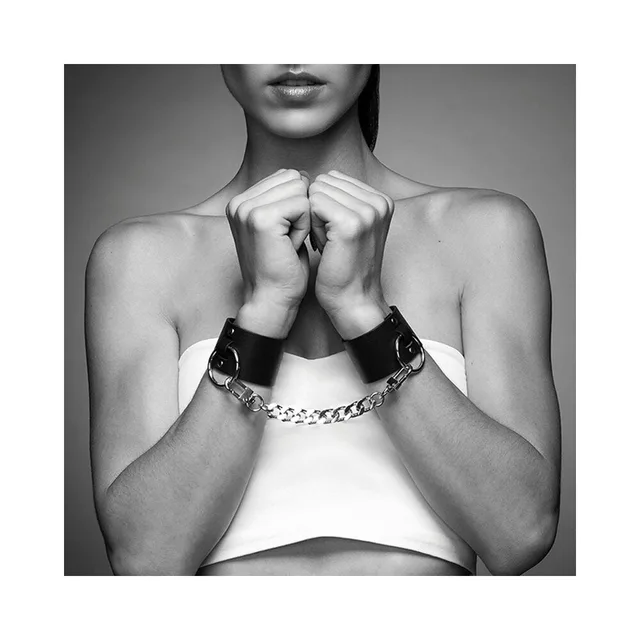 pair of wide black Maze wrist cuffs joined by a silver-tone chain and buckles