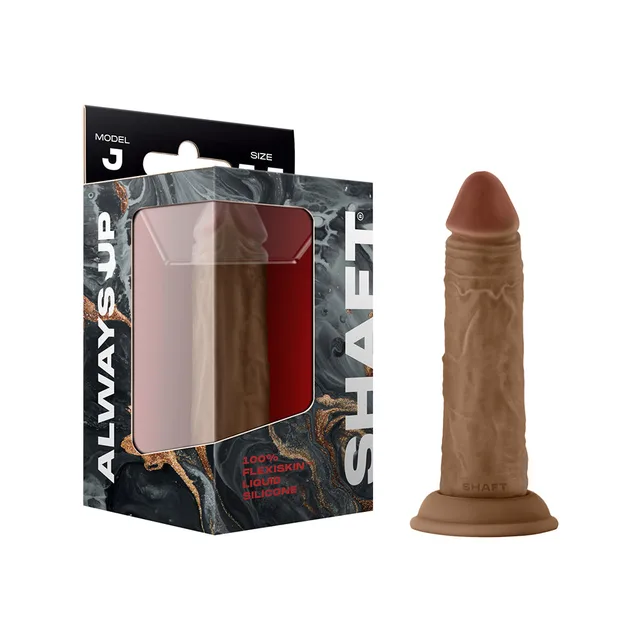 oak-toned Shaft Model J textured silicone dildo beside black retail box