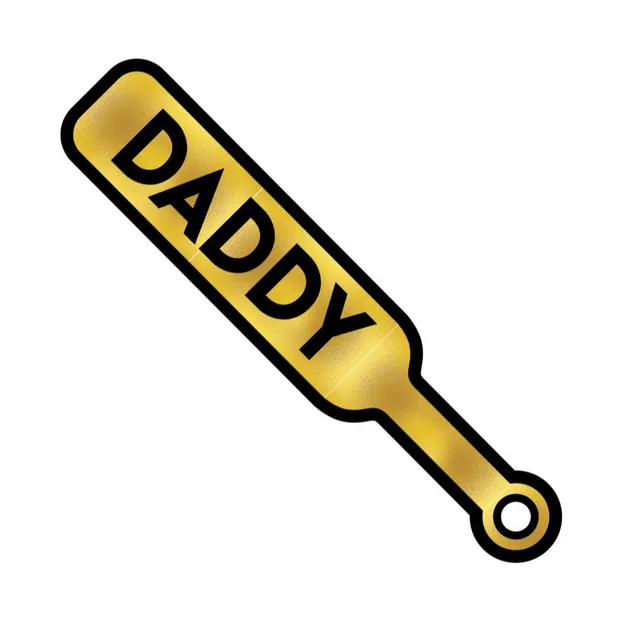 Close-up of gold paddle pin with black DADDY text