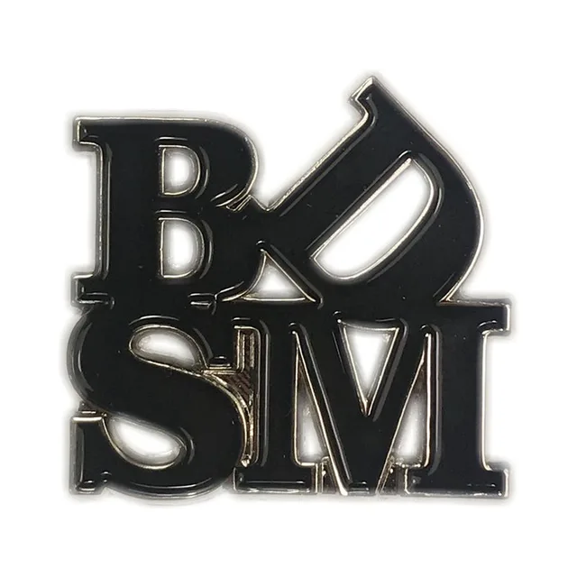 black BDSM Love enamel pin with stacked B D S M letter design
