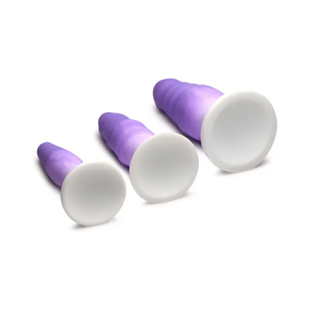 three purple silicone plugs angled to show wide white suction bases