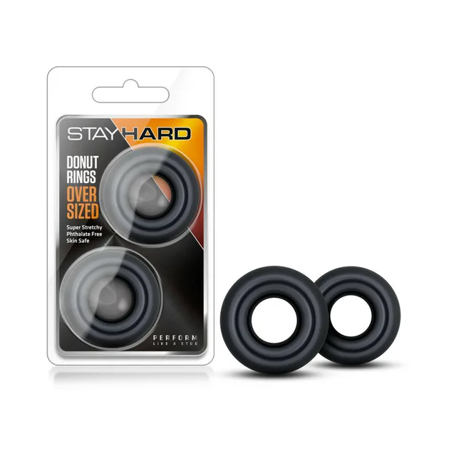 Stay Hard Donut Rings two black oversized rings beside retail package