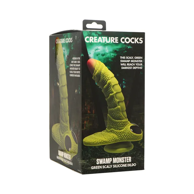 green Swamp Monster scaly silicone dildo with red tip displayed on box