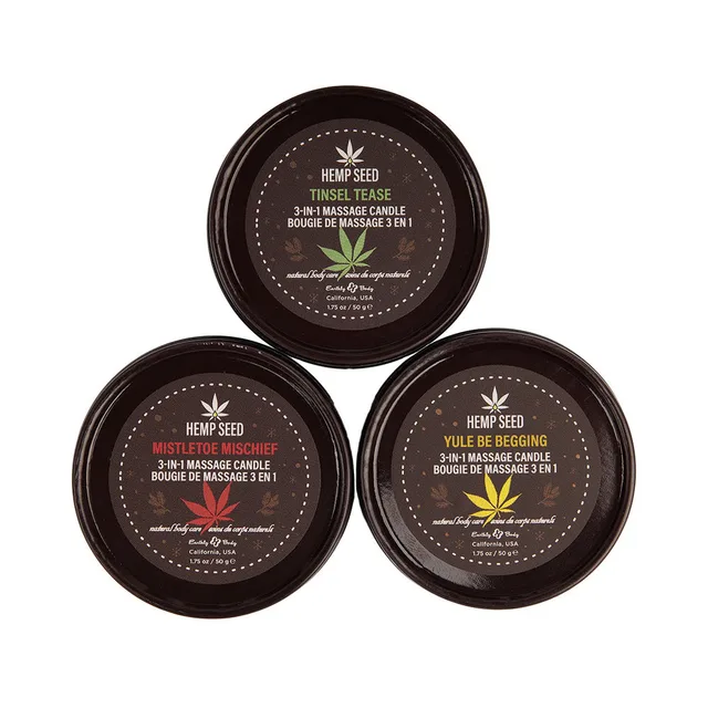 Three Earthly Body holiday candle tins arranged in a triangle