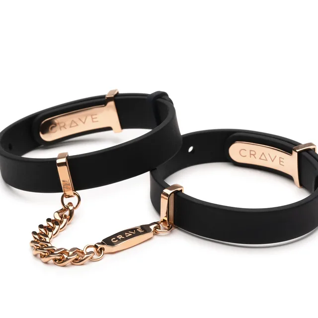 pair of black Crave silicone cuff bracelets with rose gold hardware