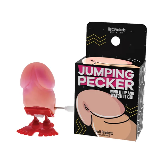 Pink Jumping Pecker wind-up toy with red feet beside black box