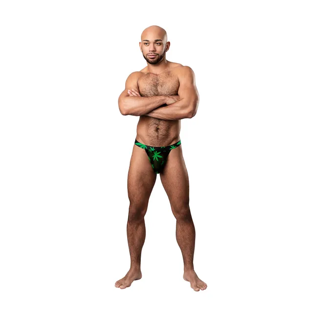 model wearing black micro thong with bright green pot-leaf print