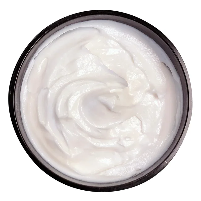 Top view of white Sunsational cream inside dark brown jar