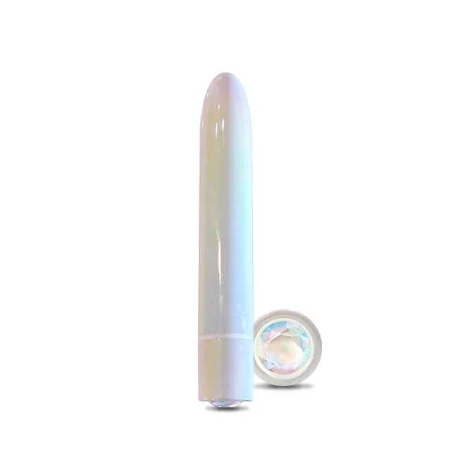 WINX Candy Cloud slim vibrator standing beside round gemstone-style base