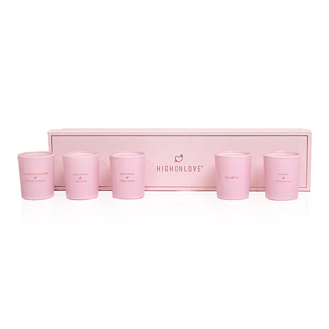 five pink HighOnLove mini massage candles arranged inside a long blush gift box